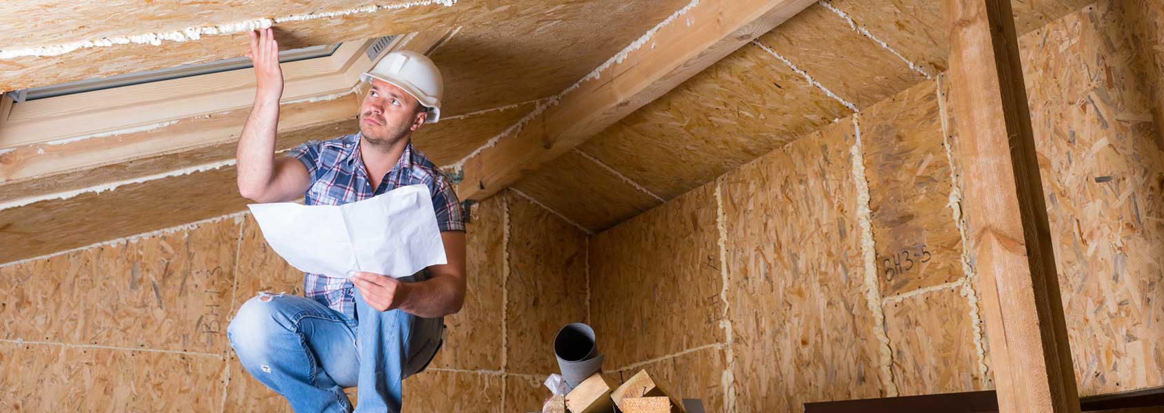 Man inspecting attic area